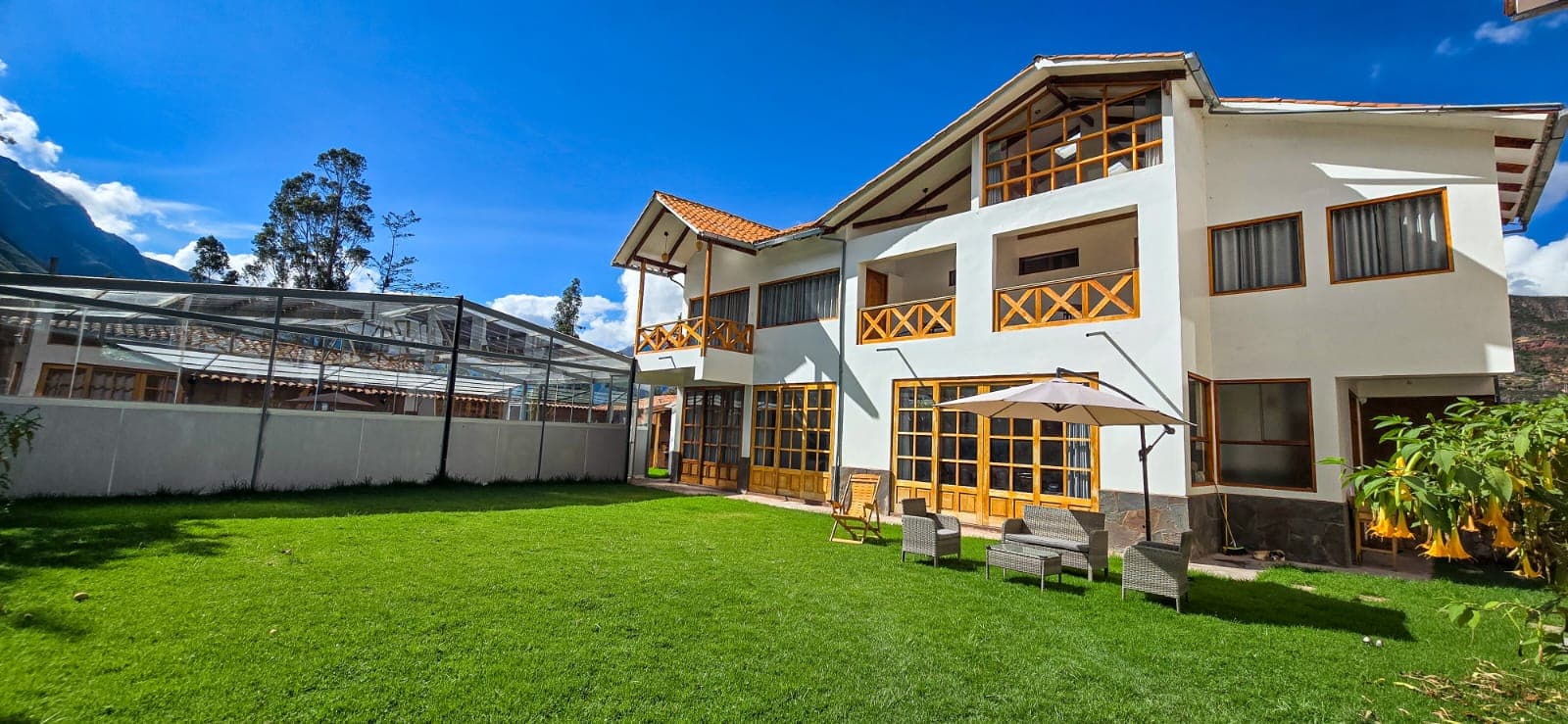 Lodge exterior with garden and Andean landscape